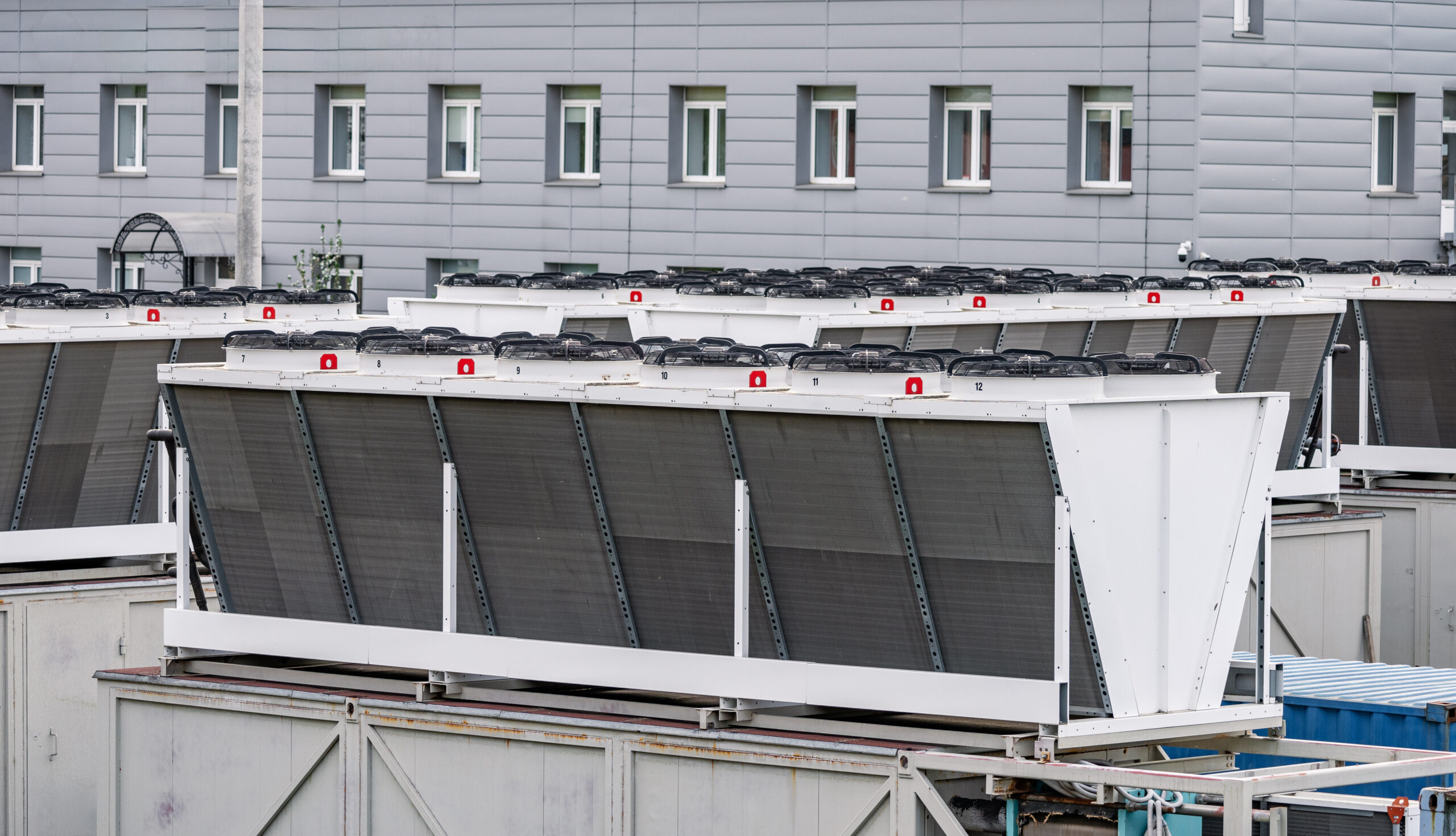 Rooftop cooling systems on a commercial building illustrating the types of upgrades required to meet MEES 2030 EPC B targets