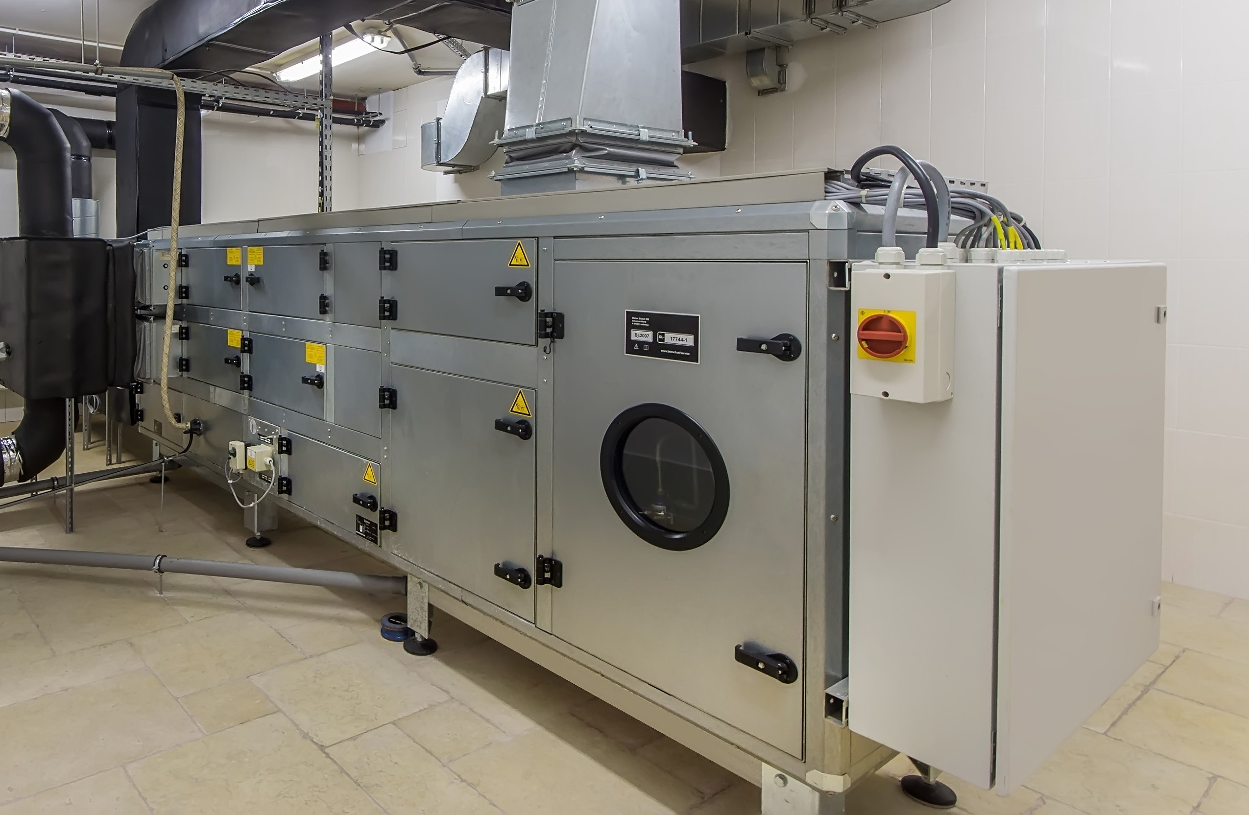Air handling unit and ductwork in a commercial plantroom illustrating building services upgrades required to improve EPC ratings