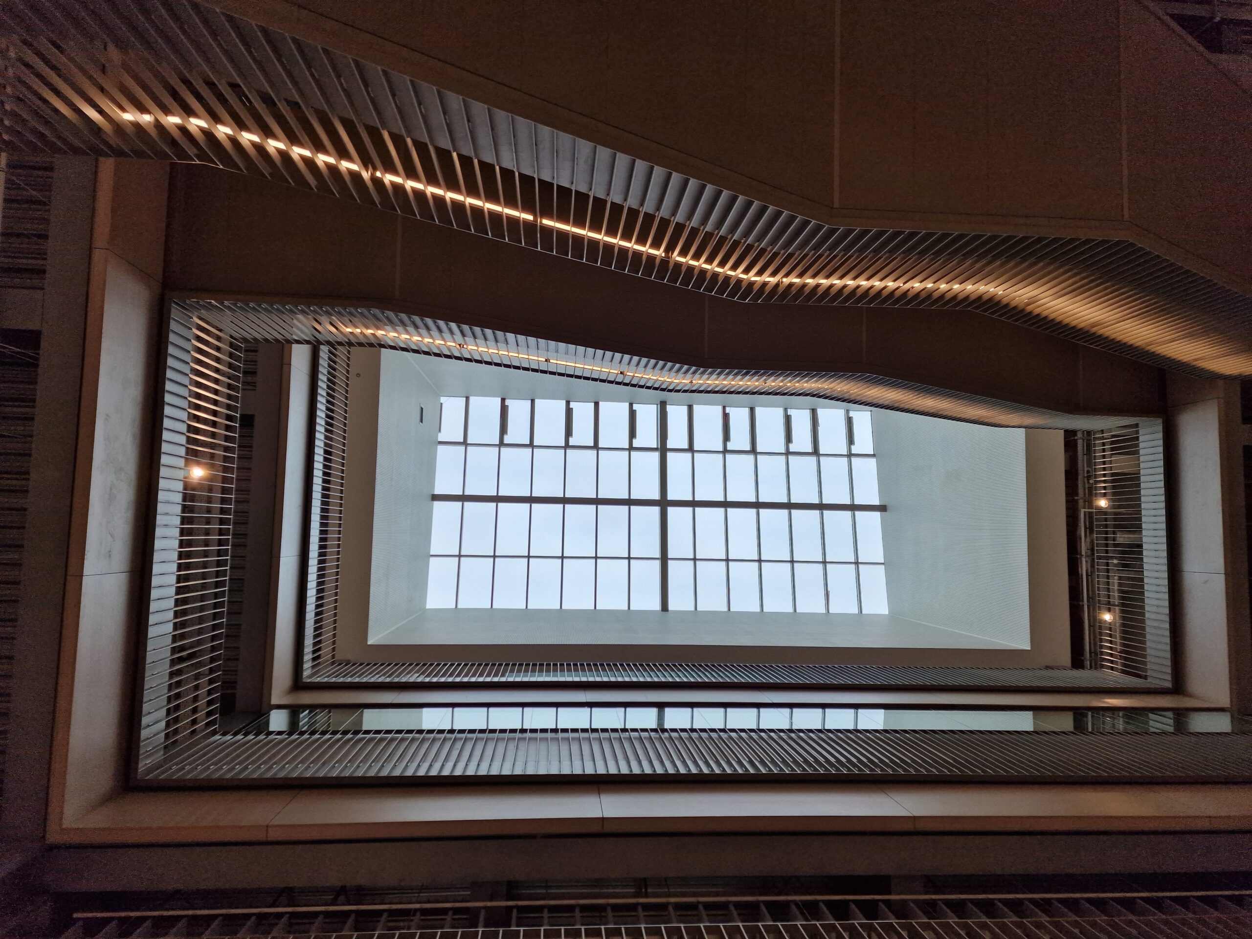 Usher Institute at Edinburgh BioQuarter: Interior view looking up through atrium with modern architecture and natural light.