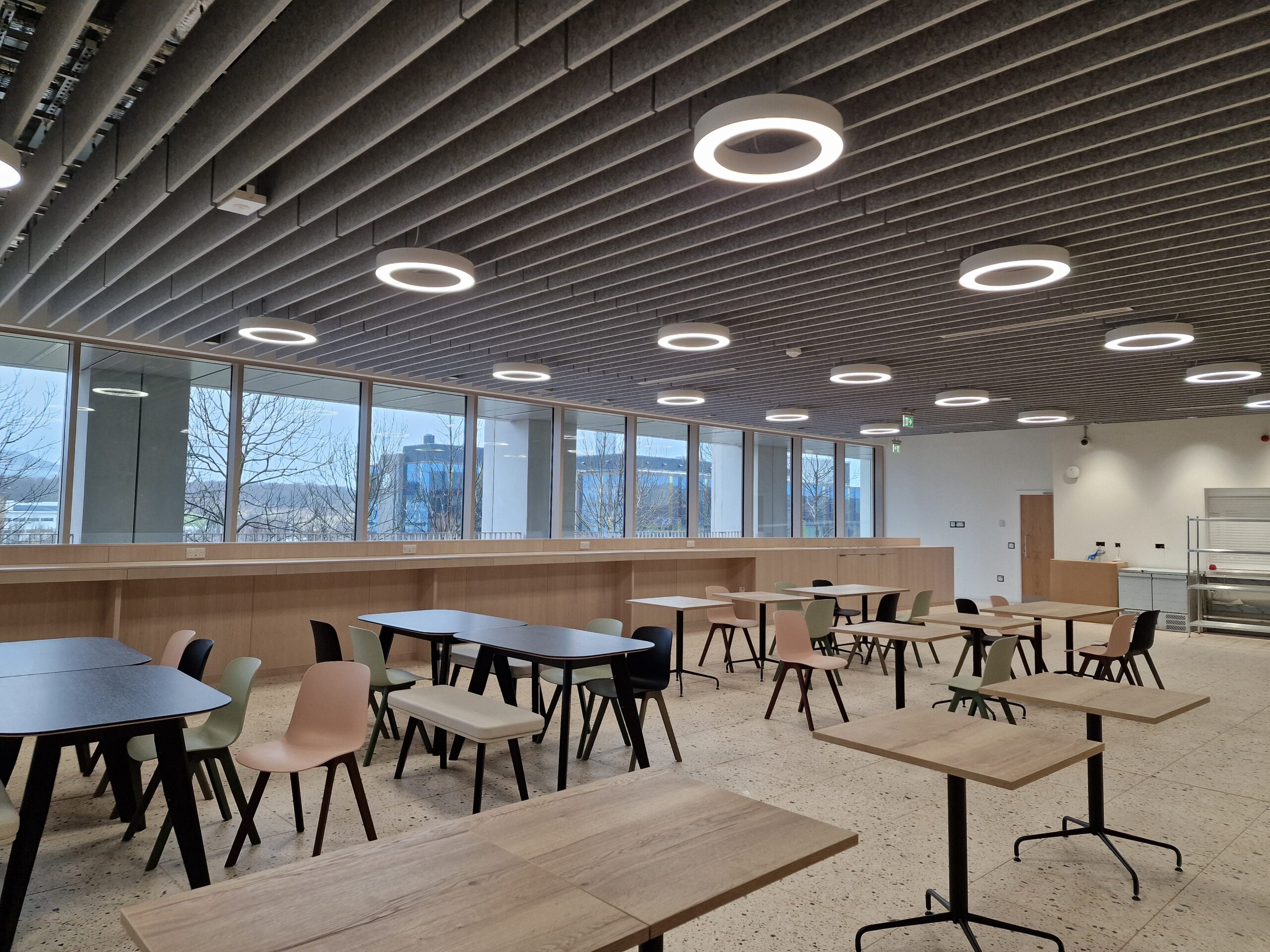 Usher Institute, Edinburgh BioQuarter: modern canteen with tables, chairs, and large windows.